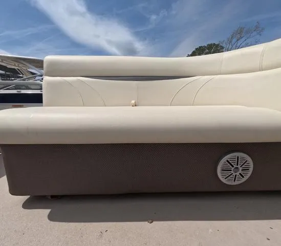 Slide: The Image of 2018 Sweetwater SW 2086 C boat interior with beige seating and speaker. - 45