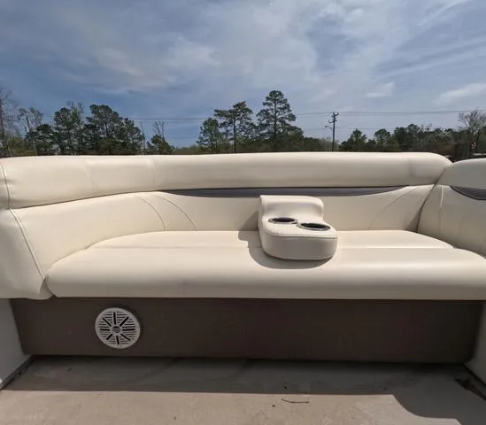 Slide: The Image of 2018 Sweetwater SW 2086 C boat interior with beige seating and cup holders. - 46