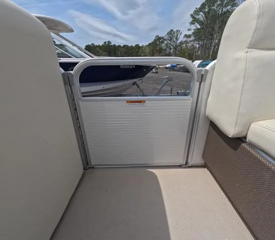 Slide: The Image of 2018 Sweetwater SW 2086 C boat interior with white seating and gate, trailer included. - 48
