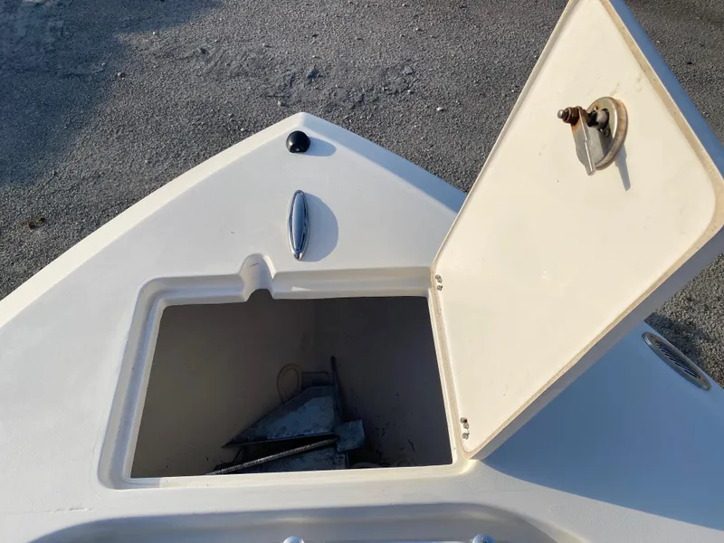 Slide: The Image of Open storage compartment on 2021 Cobia 237 Center Console boat. - 11