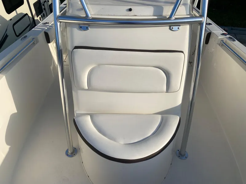 Slide: The Image of 2021 Cobia 237 Center Console boat with white cushioned seating and stainless steel railings. - 14