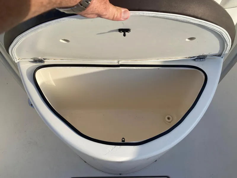Slide: The Image of Open storage compartment on a 2021 Cobia 237 Center Console boat. - 15