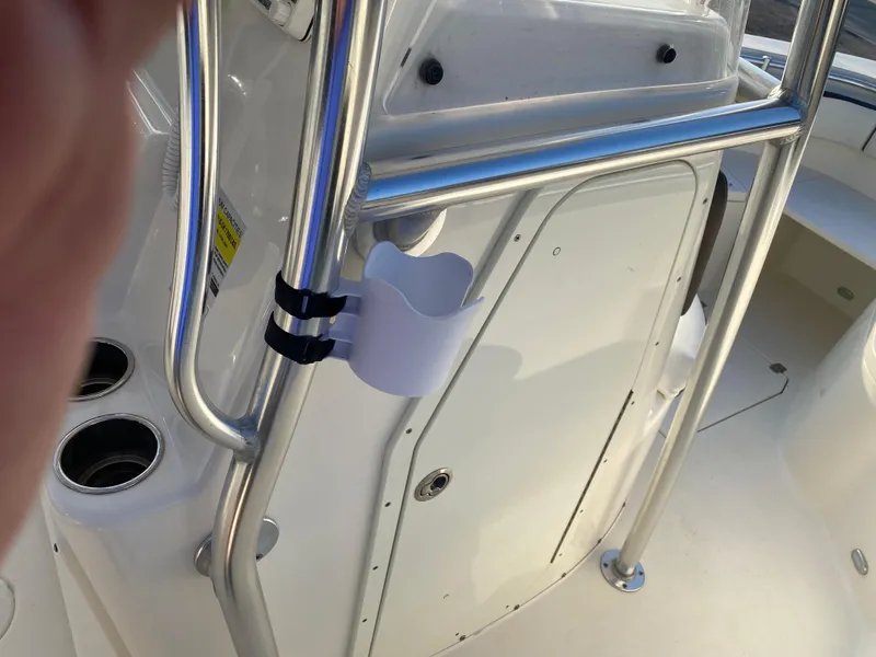 Slide: The Image of 2021 Cobia 237 Center Console boat interior with stainless steel railings and cup holder. - 18
