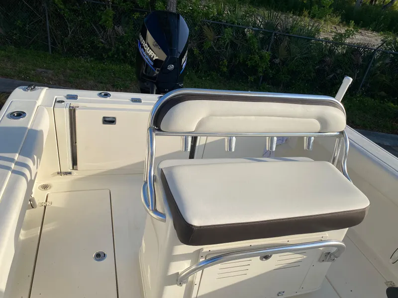 Slide: The Image of 2021 Cobia 237 Center Console boat interior with seating and outboard motor. - 20