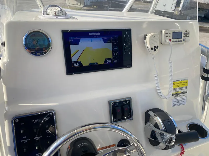 Slide: The Image of 2021 Cobia 237 Center Console dashboard with navigation system and controls. - 24