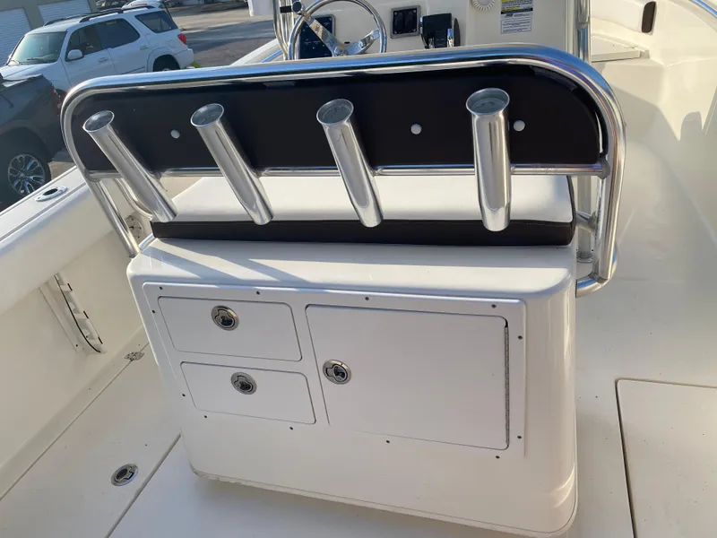 Slide: The Image of 2021 Cobia 237 Center Console boat with rod holders and storage compartments. - 25