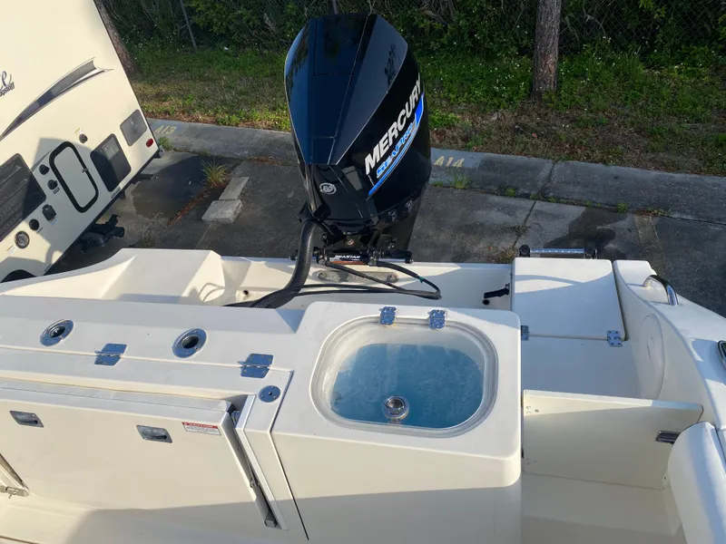 Slide: The Image of 2021 Cobia 237 Center Console boat with Mercury outboard motor and livewell. - 27