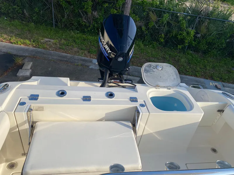 Slide: The Image of 2021 Cobia 237 Center Console boat with outboard motor and seating area. - 28