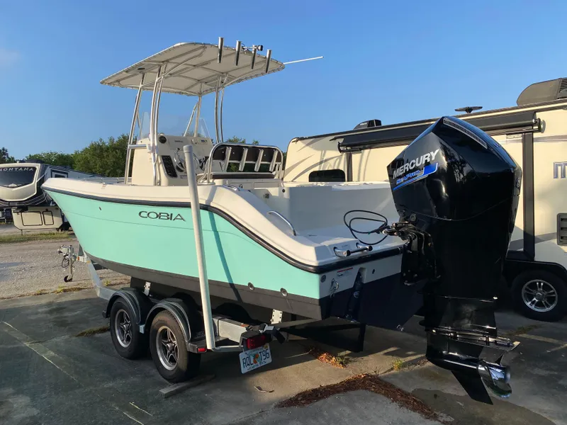Slide: The Image of 2021 Cobia 237 Center Console boat with Mercury engine on trailer. - 3