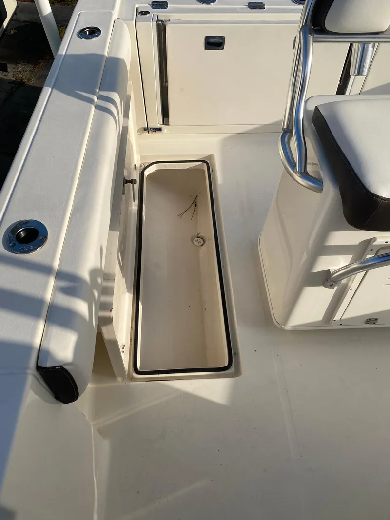 Slide: The Image of 2021 Cobia 237 Center Console boat interior with storage compartment. - 30