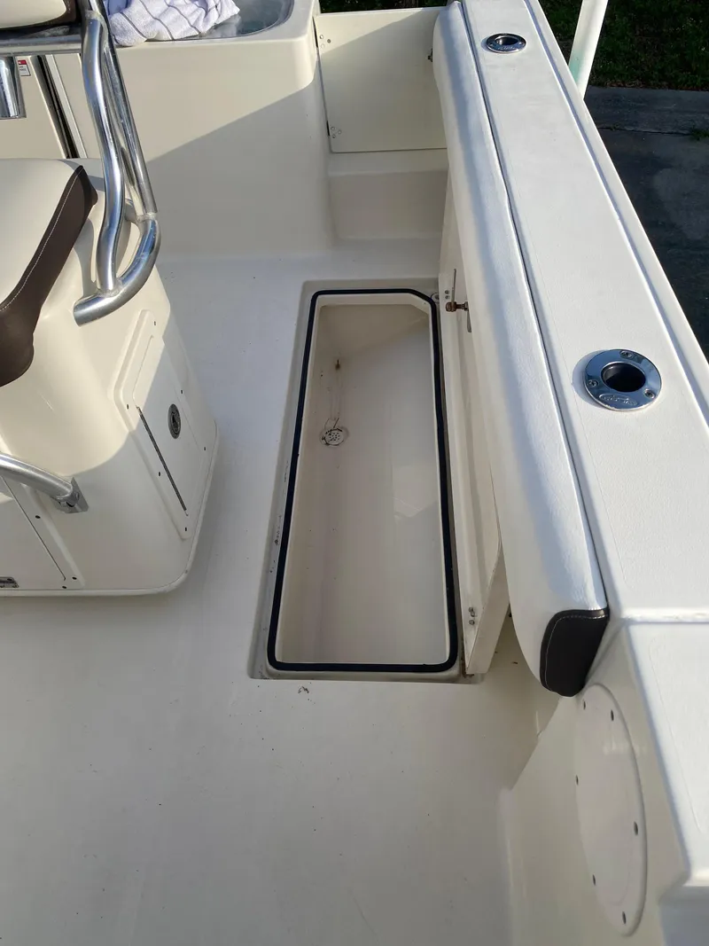 Slide: The Image of 2021 Cobia 237 Center Console boat interior with open storage compartment. - 31