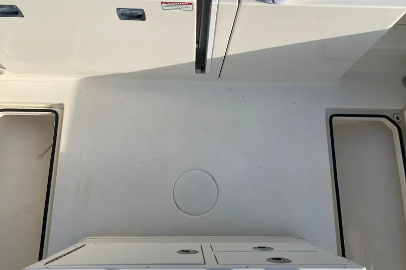 Slide: The Image of 2021 Cobia 237 Center Console boat deck with storage compartments. - 32