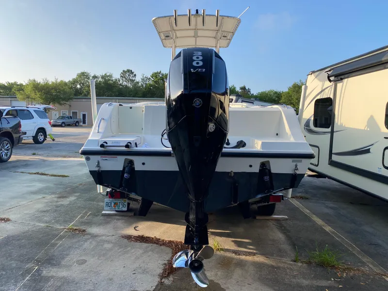 Slide: The Image of 2021 Cobia 237 Center Console boat with powerful outboard motor, parked outdoors. - 4