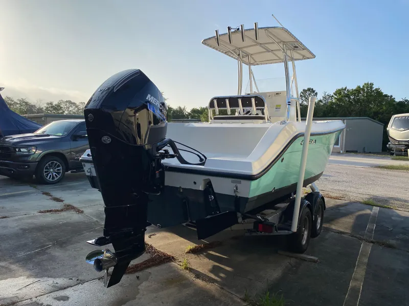 Slide: The Image of 2021 Cobia 237 Center Console boat on trailer with outboard motor in a parking area. - 5