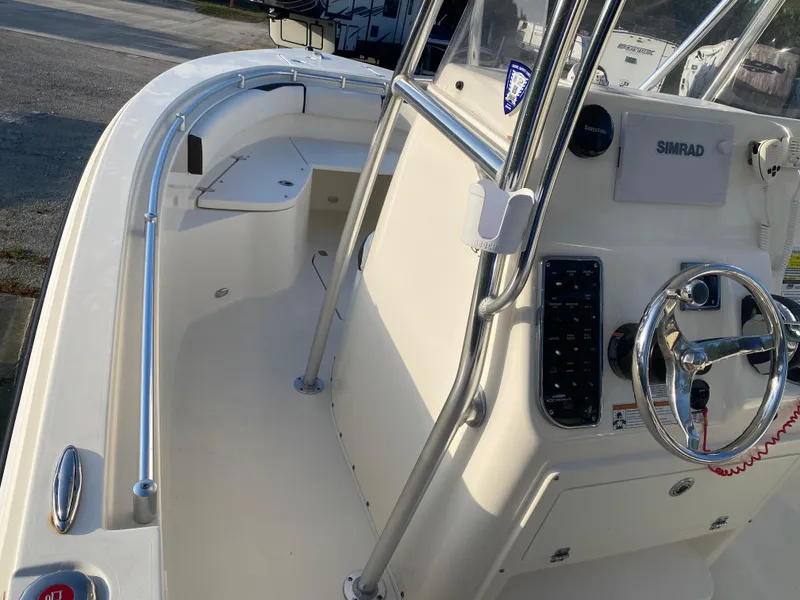 Slide: The Image of 2021 Cobia 237 Center Console boat interior with steering wheel and control panel. - 8