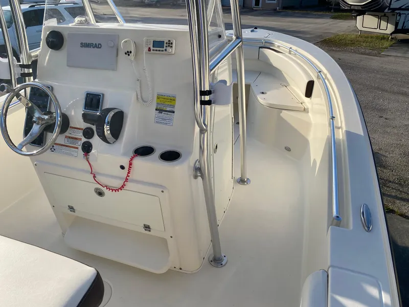 Slide: The Image of 2021 Cobia 237 Center Console boat interior with steering wheel and control panel. - 9