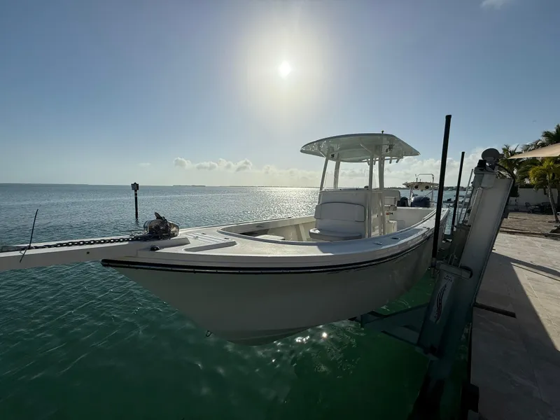 The Image of 2022 Parker 2801 Center Console boat docked by the ocean under a bright sun. - 1