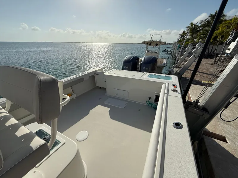 Slide: The Image of 2022 Parker 2801 Center Console boat docked by the ocean under a clear sky. - 11