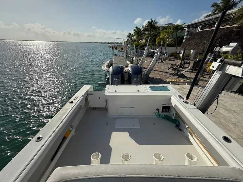 Slide: The Image of 2022 Parker 2801 Center Console boat docked by a sunny waterfront. - 12