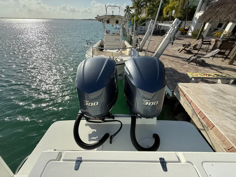 Slide: The Image of 2022 Parker 2801 Center Console boat with twin 300 horsepower engines docked by the water. - 13