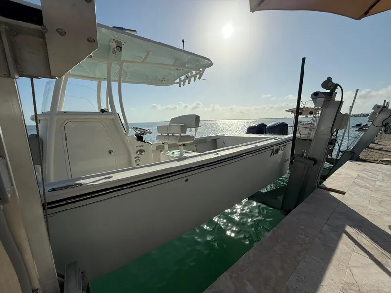 Slide: The Image of 2022 Parker 2801 Center Console boat docked by the water under a sunny sky. - 3
