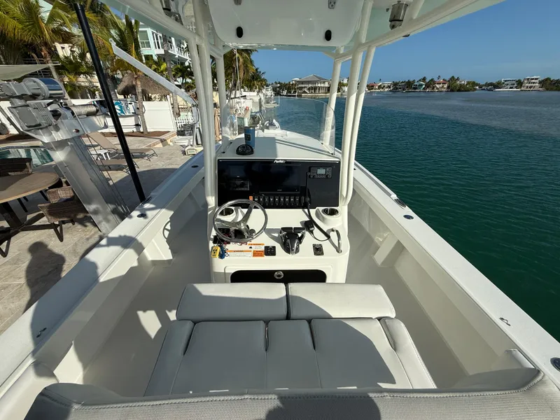 Slide: The Image of 2022 Parker 2801 Center Console boat docked by waterfront homes. - 5