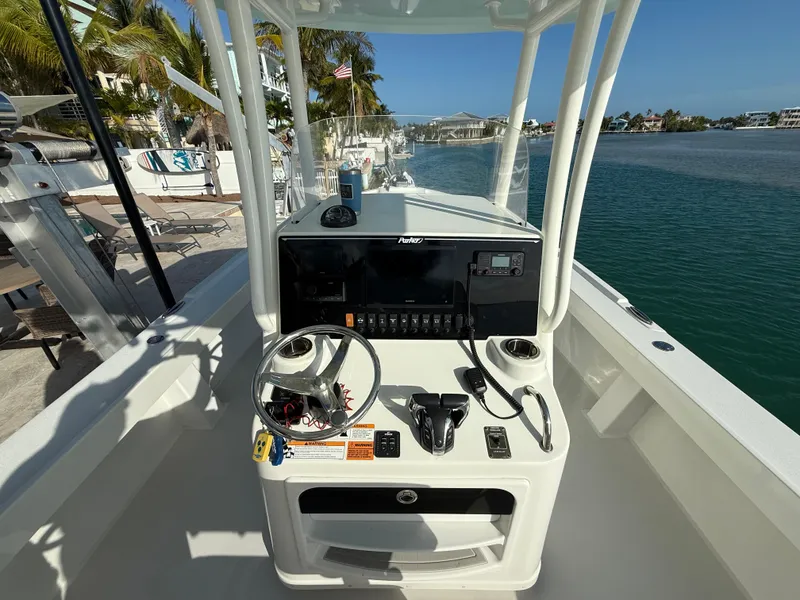 Slide: The Image of 2022 Parker 2801 Center Console boat, featuring a sleek helm and waterfront view. - 6