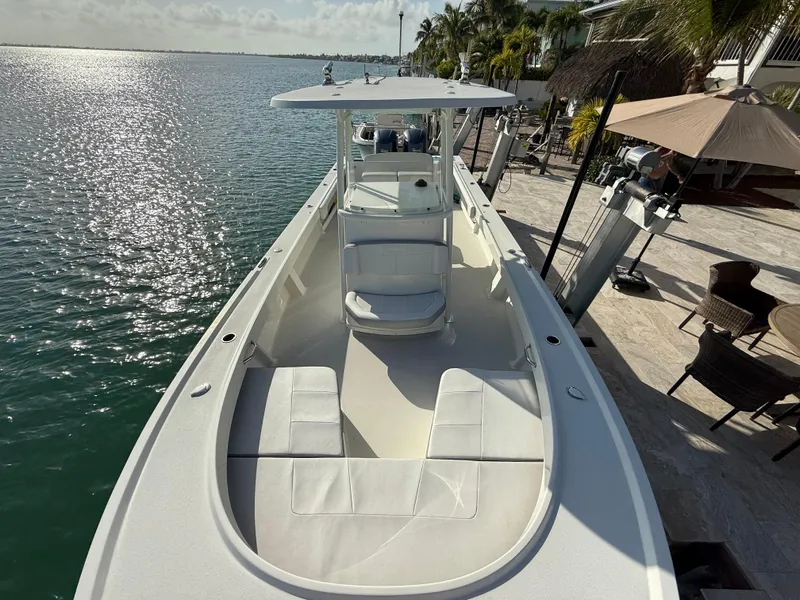 Slide: The Image of 2022 Parker 2801 Center Console boat docked by waterfront, featuring spacious seating and sleek design. - 7