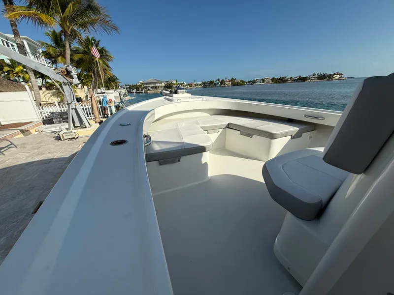 Slide: The Image of 2022 Parker 2801 Center Console boat docked by waterfront homes and palm trees. - 8