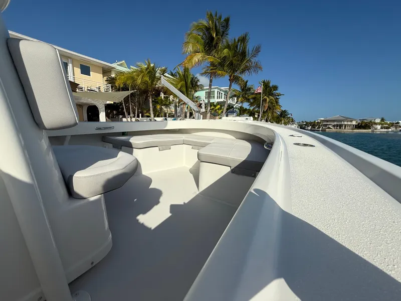 Slide: The Image of 2022 Parker 2801 Center Console boat docked near palm trees and waterfront homes. - 9