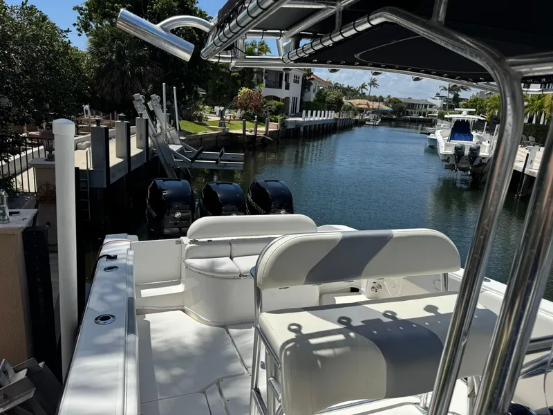 Slide: The Image of 2008 Fountain 34 Center Console boat docked in a scenic canal setting. - 10