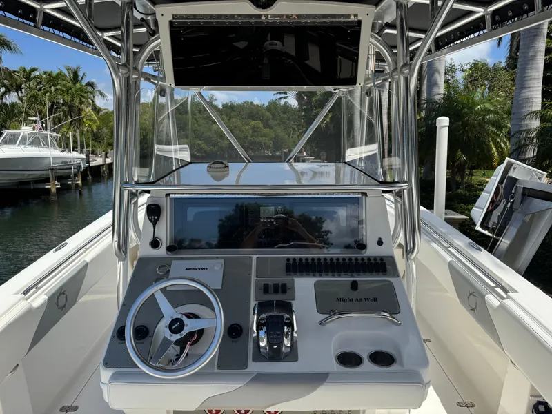 Slide: The Image of 2008 Fountain 34 Center Console boat dashboard with steering wheel and controls. - 12