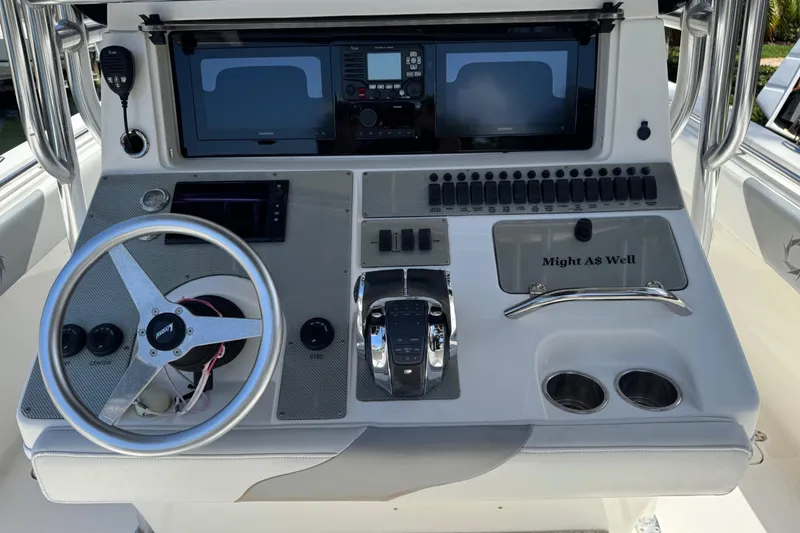 Slide: The Image of 2008 Fountain 34 Center Console dashboard with steering wheel and control panel. - 13