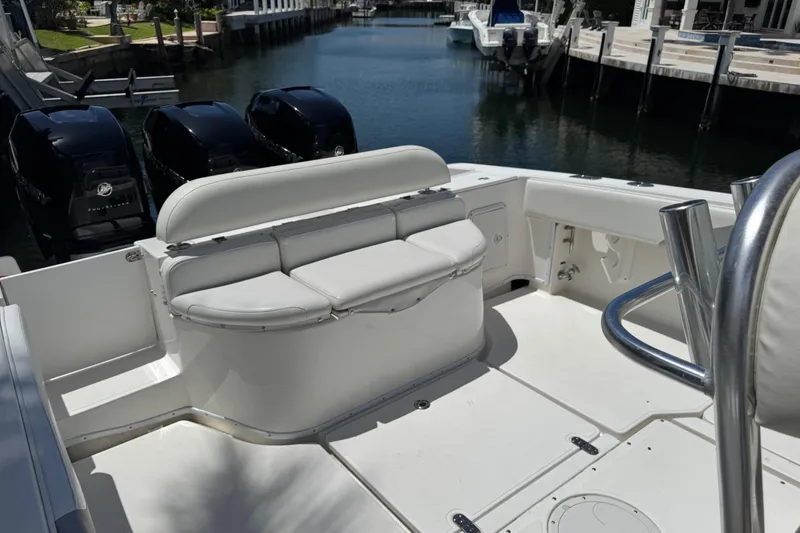 Slide: The Image of 2008 Fountain 34 Center Console boat with seating and outboard motors in a marina. - 18