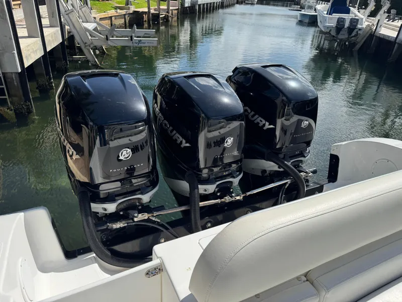 Slide: The Image of Triple Mercury outboard engines on a 2008 Fountain 34 Center Console boat. - 19