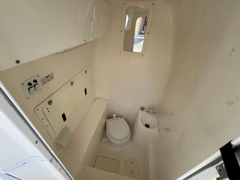 Slide: The Image of 2008 Fountain 34 Center Console boat interior with compact marine toilet and storage. - 20