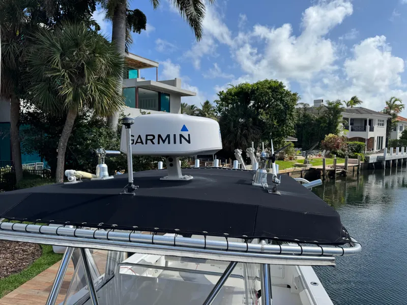 Slide: The Image of 2008 Fountain 34 Center Console boat with Garmin radar, docked near waterfront homes. - 21