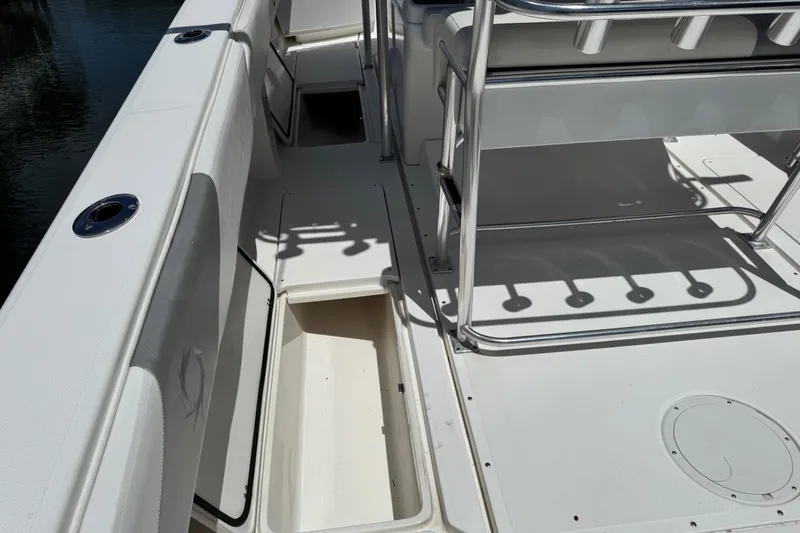 Slide: The Image of 2008 Fountain 34 Center Console boat deck with storage compartment and seating area. - 24