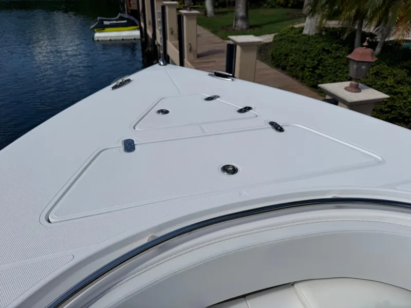 Slide: The Image of 2008 Fountain 34 Center Console boat deck, docked by a waterfront. - 26