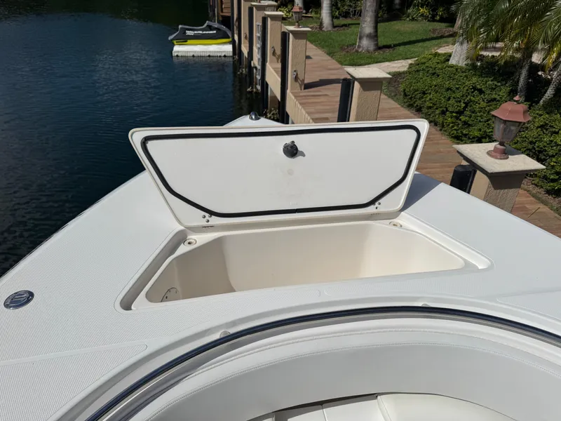 Slide: The Image of 2008 Fountain 34 Center Console boat with open storage compartment by a dock. - 27