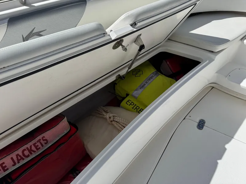 Slide: The Image of Storage compartment of 2008 Fountain 34 Center Console with life jackets and safety gear. - 28