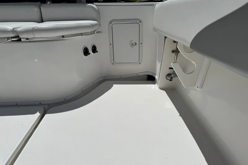 Slide: The Image of 2008 Fountain 34 Center Console boat interior with white seating and storage compartments. - 31