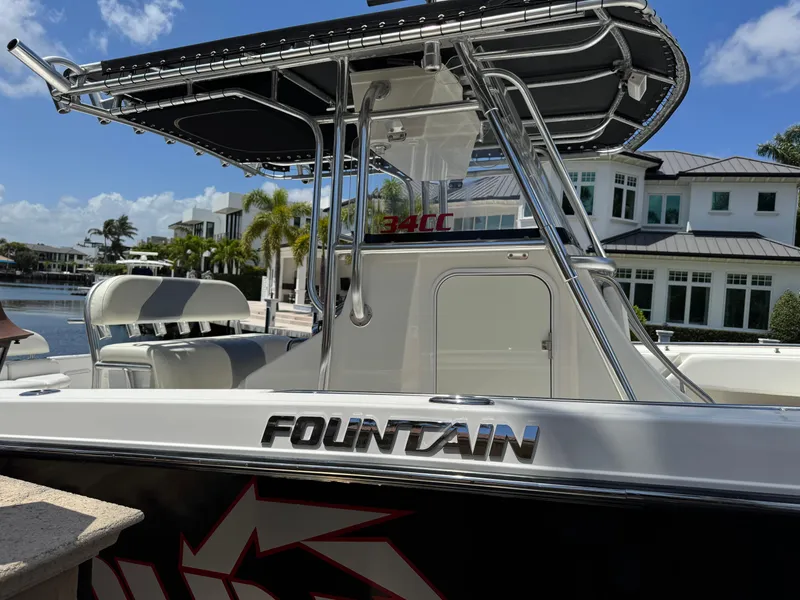 Slide: The Image of 2008 Fountain 34 Center Console boat docked near waterfront homes. - 5