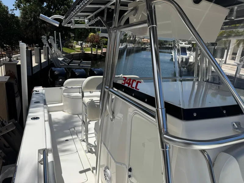 Slide: The Image of 2008 Fountain 34 Center Console boat docked, featuring sleek design and spacious deck. - 8