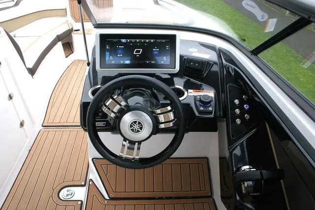 Slide: The Image of 2022 Yamaha Boats 252SD dashboard with modern steering and touchscreen controls. - 9