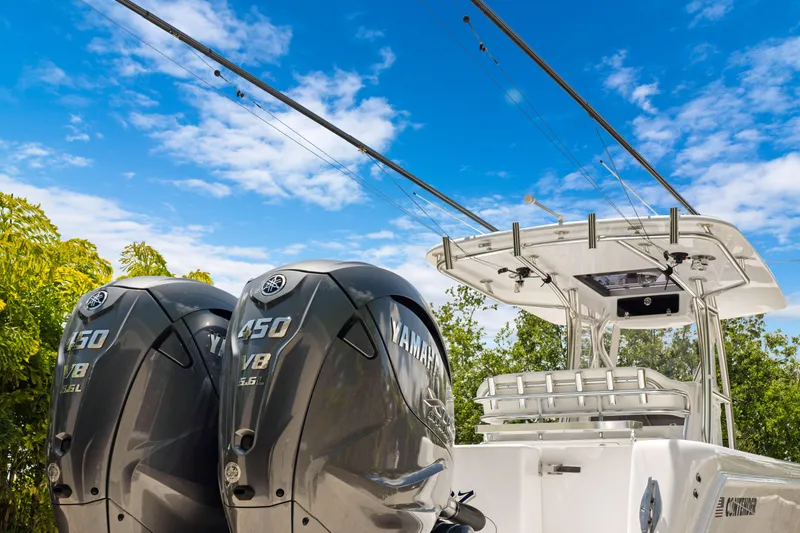 Slide: The Image of 2024 Contender 35 ST boat with dual Yamaha 450 engines under a clear blue sky. - 12