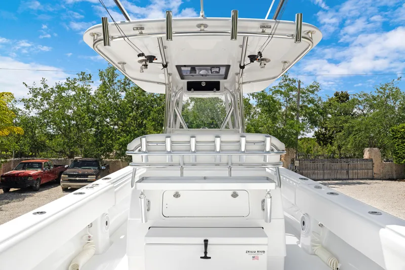 Slide: The Image of 2024 Contender 35 ST boat with center console and rod holders, parked outdoors. - 25