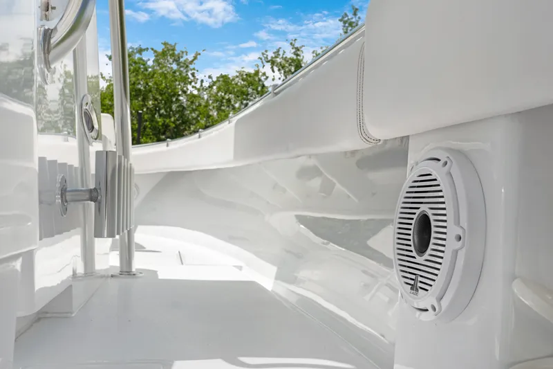 Slide: The Image of 2024 Contender 35 ST boat interior with speaker, sleek white design, and clear blue sky. - 26