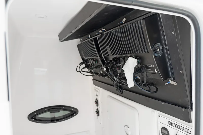 Slide: The Image of 2024 Contender 35 ST boat interior with electronic equipment and wiring. - 28