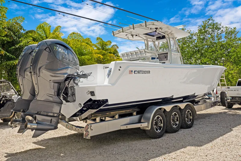 Slide: The Image of 2024 Contender 35 ST boat with triple Yamaha engines on a trailer. - 7